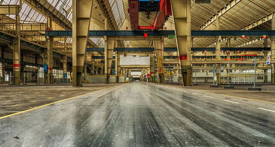 A large commercial warehouse interior with a wet polished concrete floor